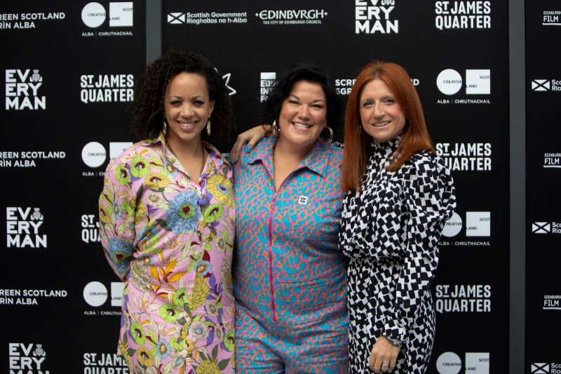 A group of three people smiling at the Edinburgh International Film Festival