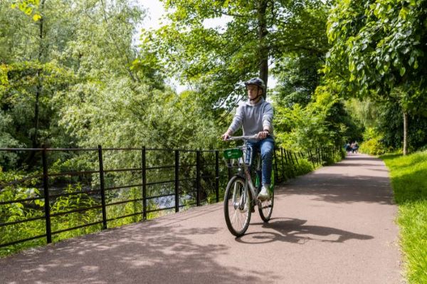 A person riding a bicycle in Kelvingrove Park